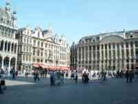 Big old buildings around a square full of people