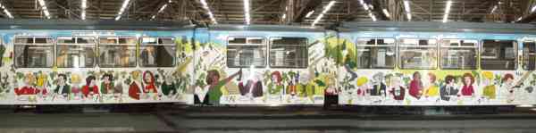 Long view of the party car, which is decorated with people enjoying a meal together