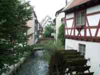 Small river running between city buildings