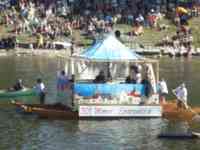 Person in a mayor costume inside a tent on a boat