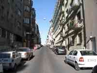 Buildings and parked cars along a city street