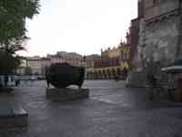 Sculpture of a huge sideways head in plaza