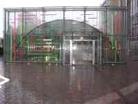 Glass and metal facade and door with red and green neon lights