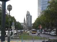 Median of a city street with a sculpture and a church in the background