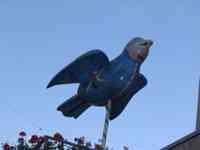 Sparrow sculpture with face of General Wallenstein and images of people competing in a river game